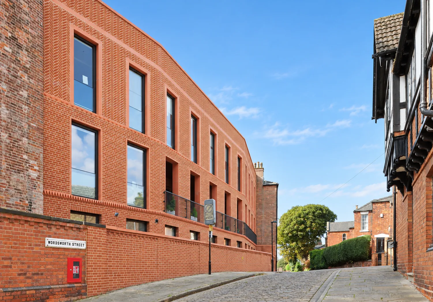 Bailgate Court, Lincoln — new red-brick terrace curving along a cobbled street
