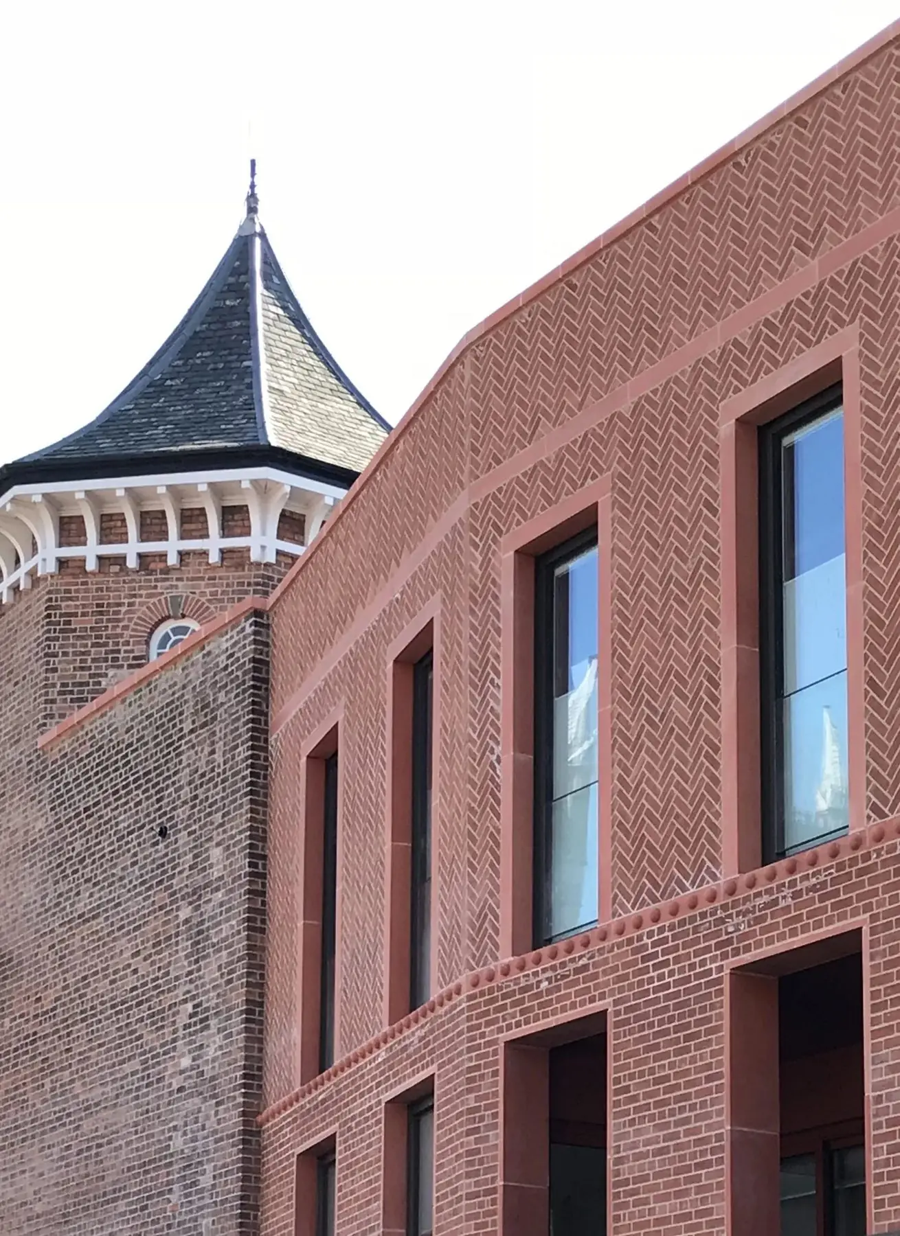 New brick elevation meeting a Victorian turret
